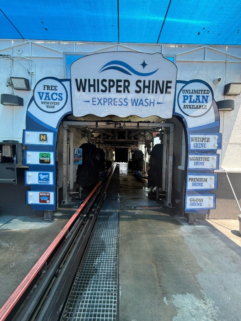 Close-up of the Whisper Shine Express Wash arched tunnel entrance